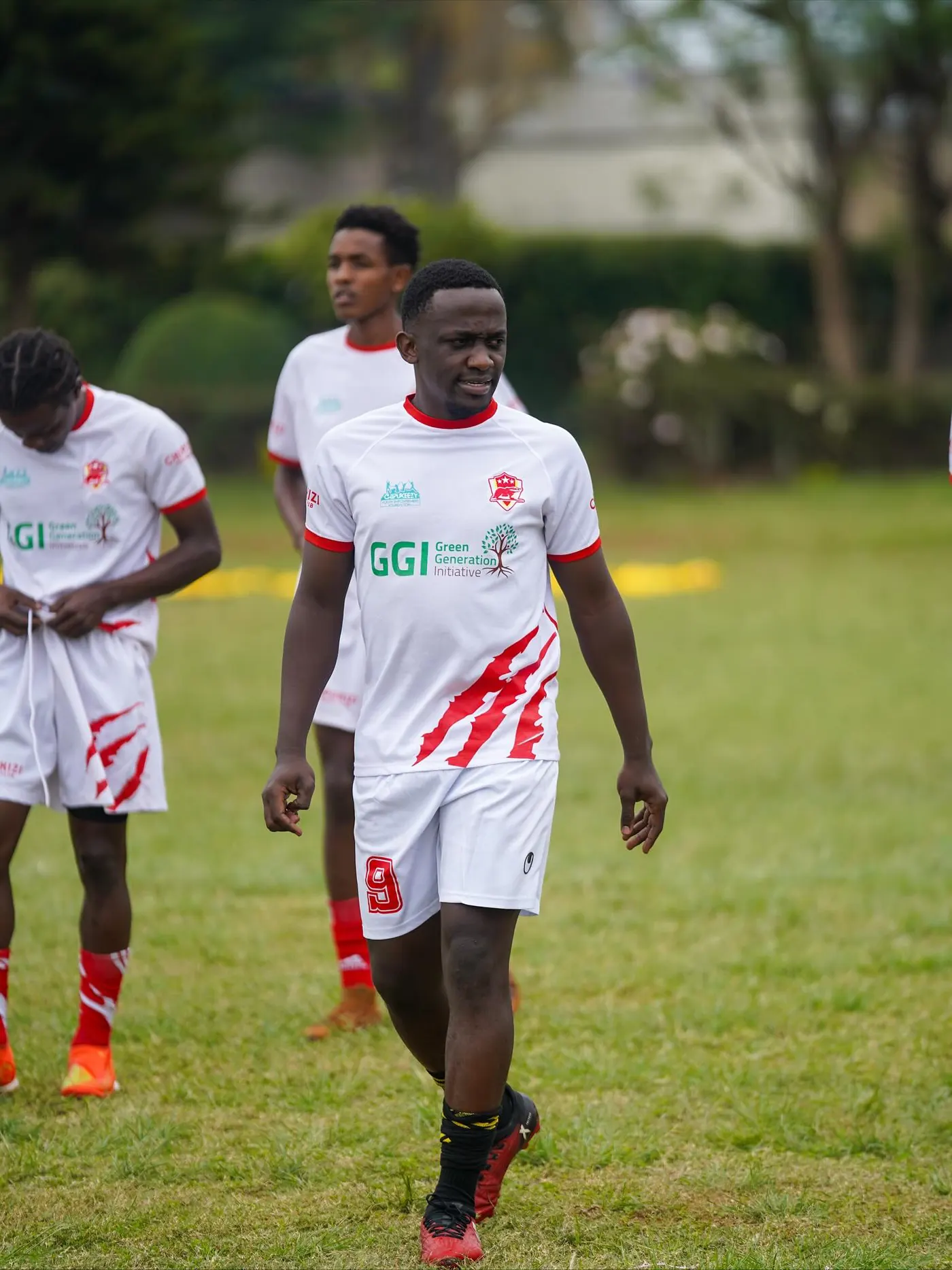 Chipukizi FC players warming up before kickoff.