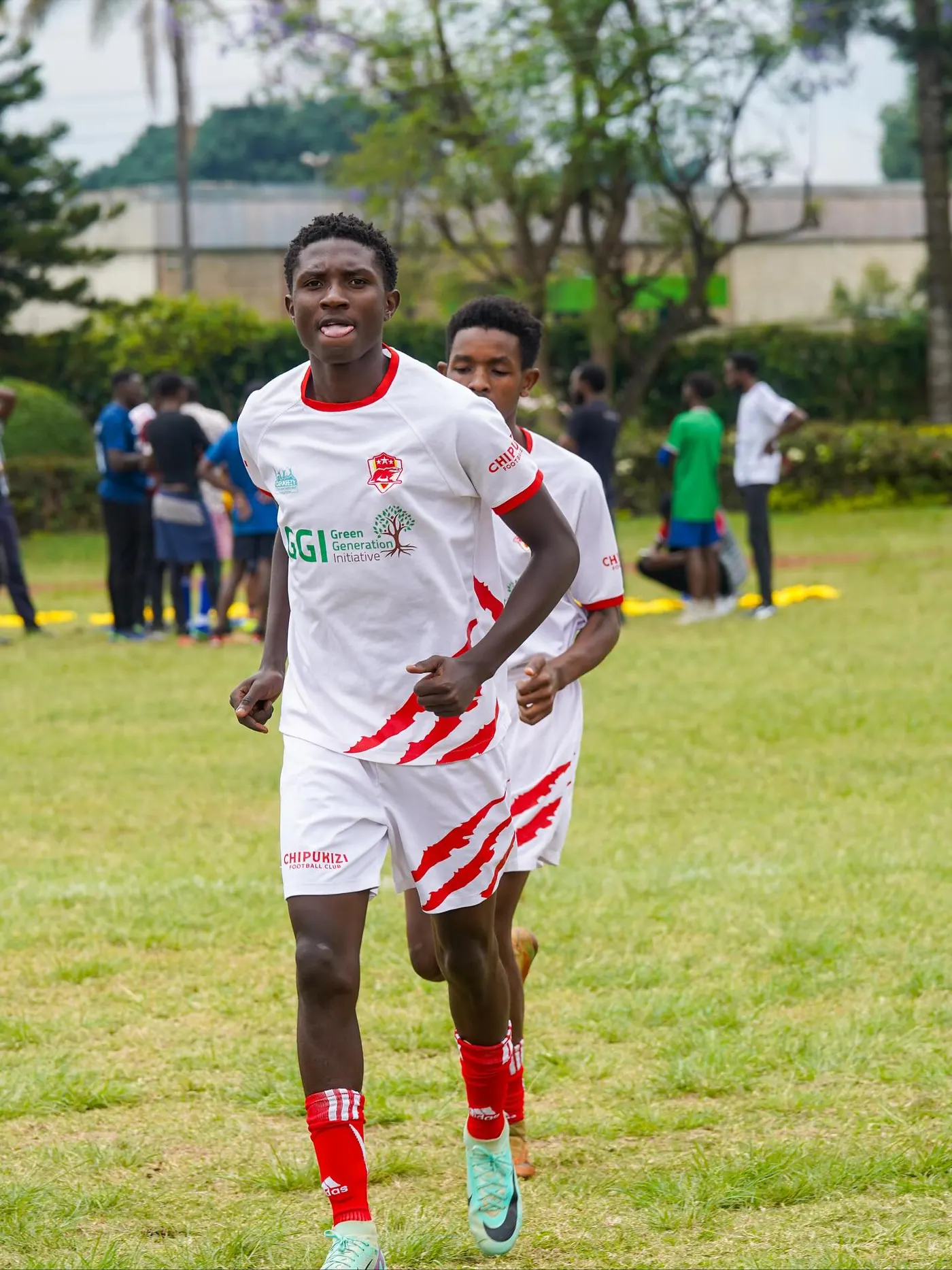 Chipukizi FC players warming up before kickoff.
