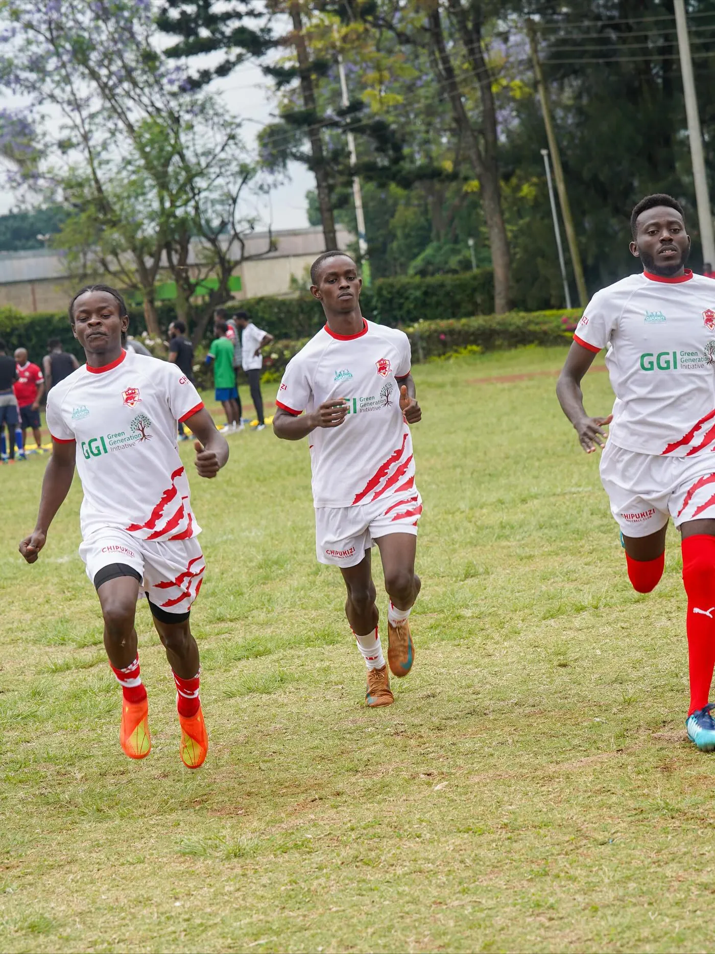 Chipukizi FC players warming up before kickoff.