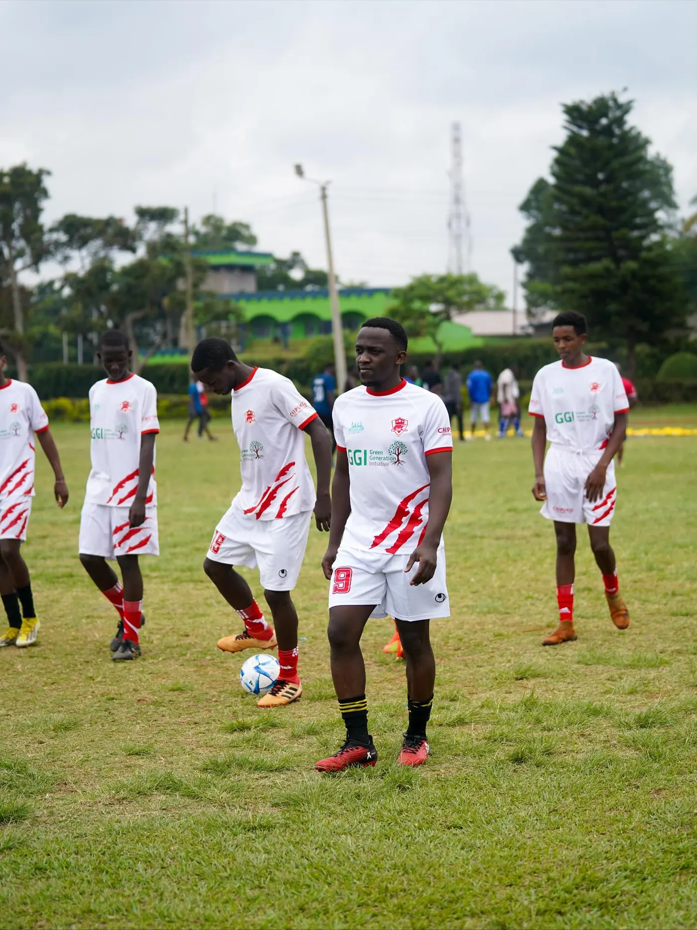 Chipukizi FC players warming up before kickoff.