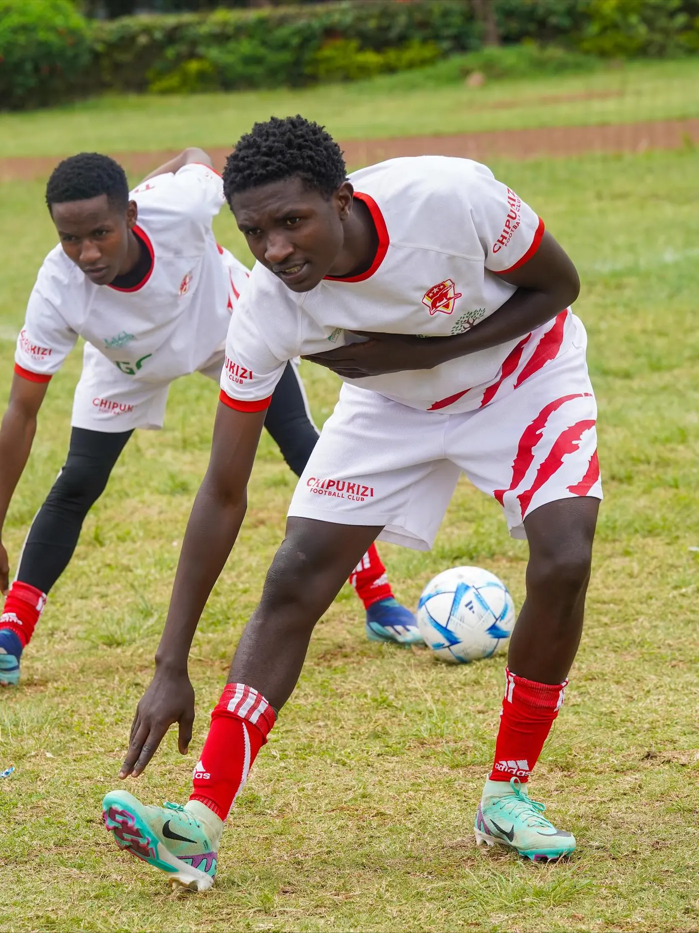 Chipukizi FC players warming up before kickoff.
