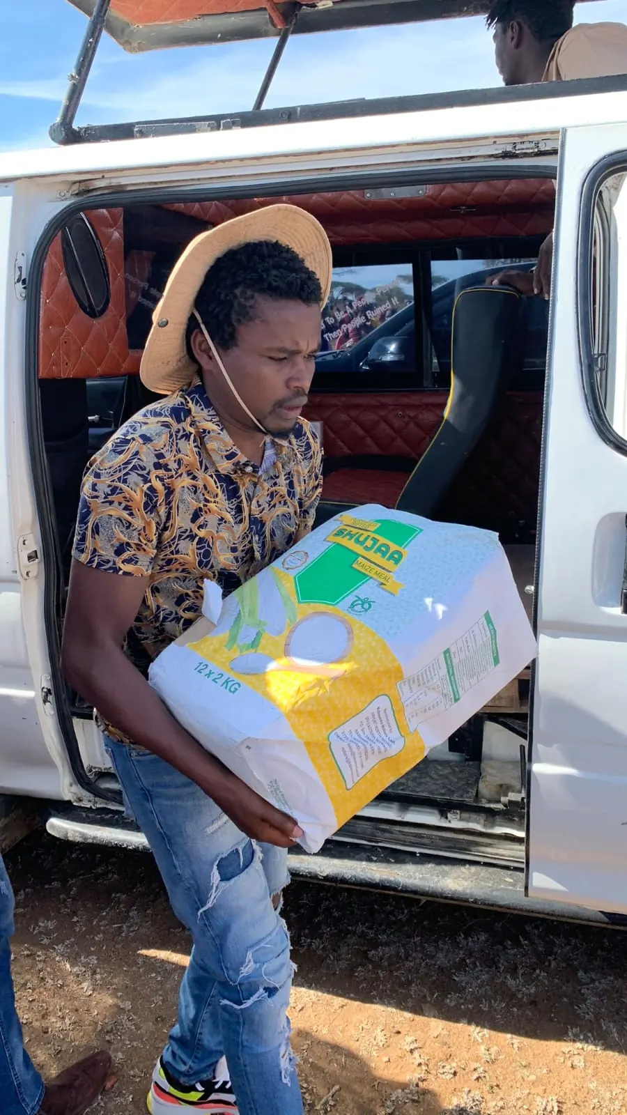 Volunteers unloading boxes of learning materials for the school.