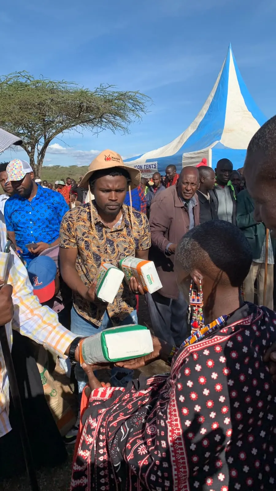A partner handing donated learning materials over to CYEF.