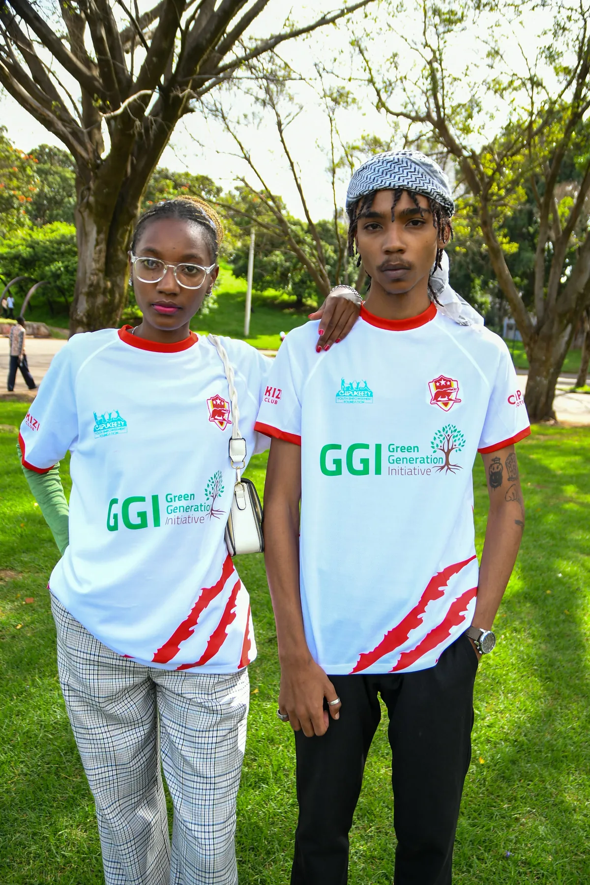 Two people wearing the Chipukizi FC jersey