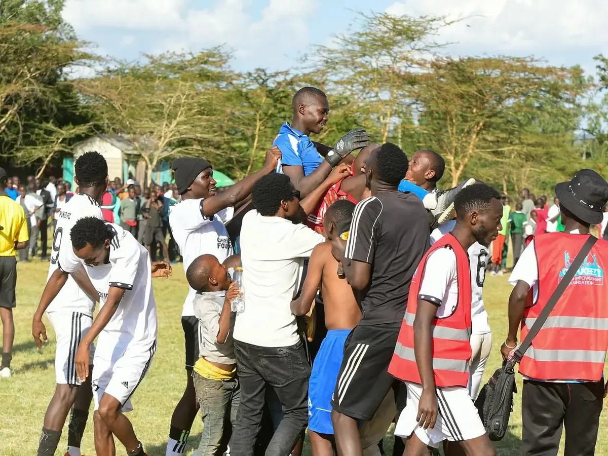Chipukizi FC players and supporters celebrating together after a match