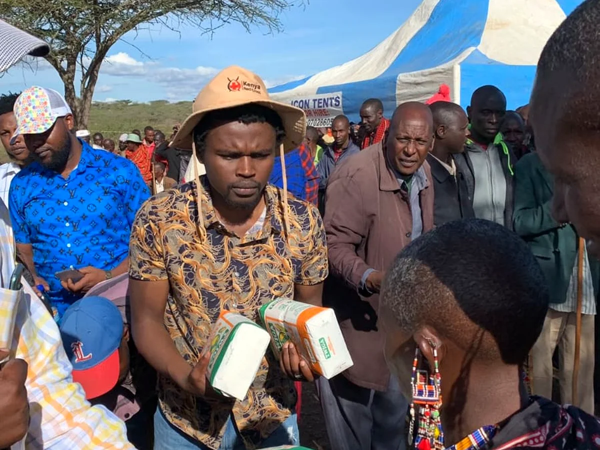 CYEF team members handing education support items to community members