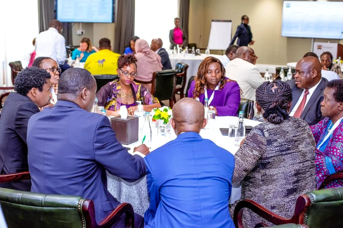 Stakeholders seated around tables during a consultative workshop